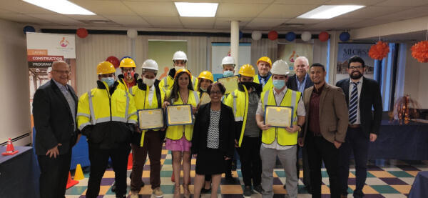 Students who graduated the Latino Construction Program hold their diplomas