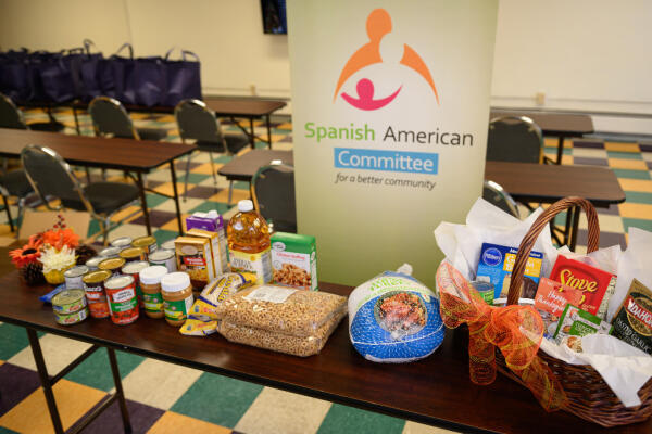 A table of Thanksgiving food donations for Latino families in need