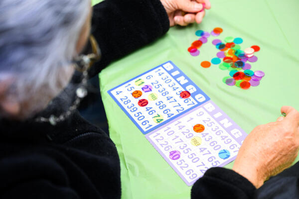 A Hispanic woman plays bingo at our senior social program