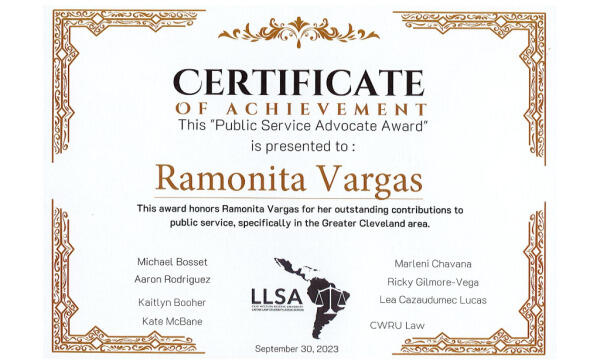 A certificate of achievement for the Public Service Advocate Award presented to Ramonita Vargas, recognizing her outstanding contributions to public service. The certificate lists names and features a decorative border and a map logo.